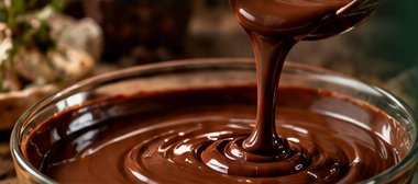 Pouring smooth melted couverture chocolate